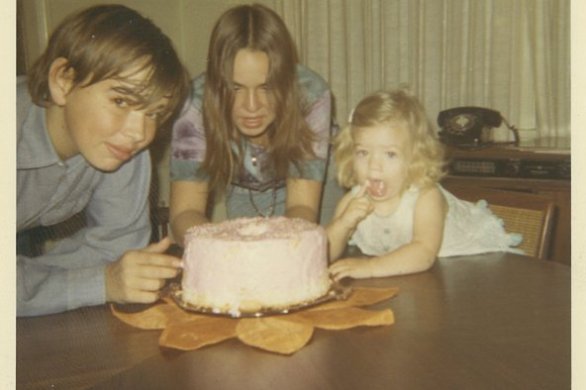 With my brother and sister and a birthday cake